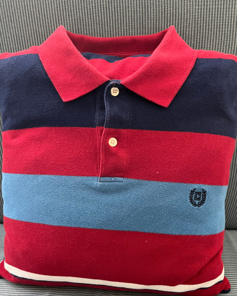 Red, navy blue, light blue, and white wide striped polo shirt pillow made from a customer's clothes. The 16x16 inch pillow has a collar.