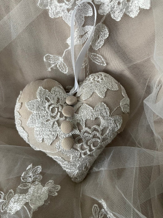 4x4 heart-shaped beige wedding ornament with white embroidered lace made from repurposed wedding gown.